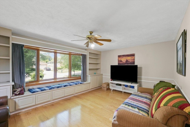302 S Orr Dr, Normal, IL 61761 - living area with light wood-type flooring, ceiling fan, a textured ceiling, and built in features