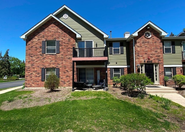 1340 Mcdowell Rd Unit 201, Naperville, IL 60563 - view of front of house featuring a balcony, a front lawn, and brick siding