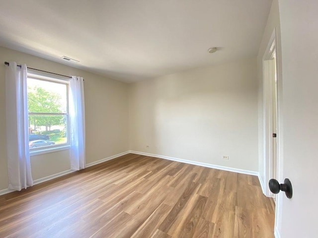 1340 Mcdowell Rd Unit 201, Naperville, IL 60563 - spare room featuring light wood-style flooring and baseboards