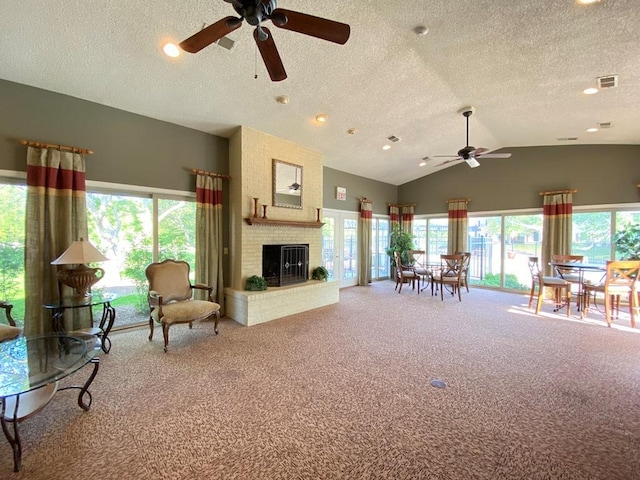 1340 Mcdowell Rd Unit 201, Naperville, IL 60563 - carpeted living area featuring a ceiling fan, vaulted ceiling, a fireplace, a textured ceiling, and recessed lighting