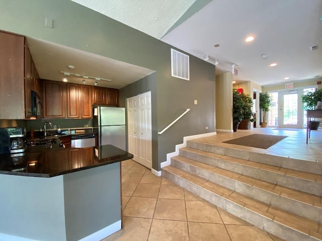 1340 Mcdowell Rd Unit 201, Naperville, IL 60563 - kitchen with freestanding refrigerator, black microwave, light tile patterned floors, rail lighting, and recessed lighting