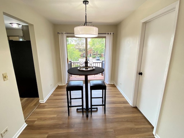 1340 Mcdowell Rd Unit 201, Naperville, IL 60563 - dining room featuring wood finished floors and baseboards