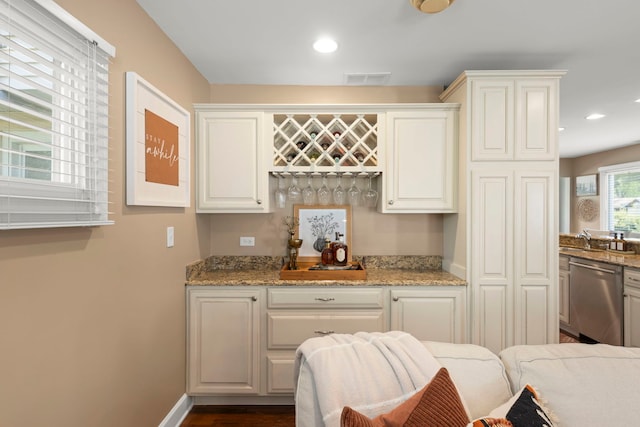 1341 S Sumner St, Wheaton, IL 60189 - kitchen with stainless steel dishwasher, white cabinets, recessed lighting, light stone counters, and dark wood-style flooring