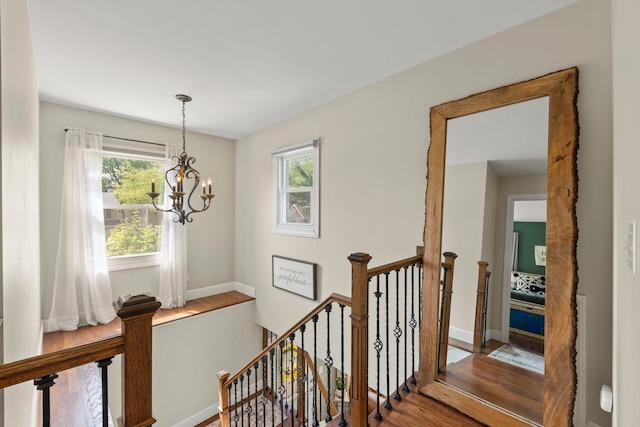 1341 S Sumner St, Wheaton, IL 60189 - corridor featuring an upstairs landing, wood finished floors, plenty of natural light, and a chandelier