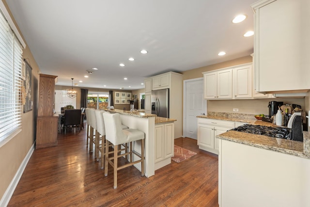 1341 S Sumner St, Wheaton, IL 60189 - kitchen with stainless steel fridge, dark wood finished floors, recessed lighting, a kitchen bar, and a kitchen island