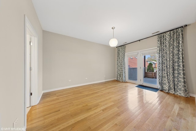 2033 N Damen Ave Unit 2N, Chicago, IL 60647 - empty room featuring french doors and light wood-style floors