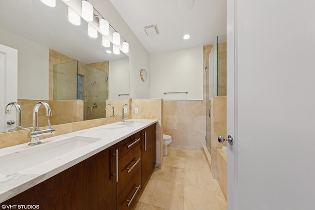 2033 N Damen Ave Unit 2N, Chicago, IL 60647 - bathroom with double vanity, a stall shower, tile walls, wainscoting, and tile patterned flooring