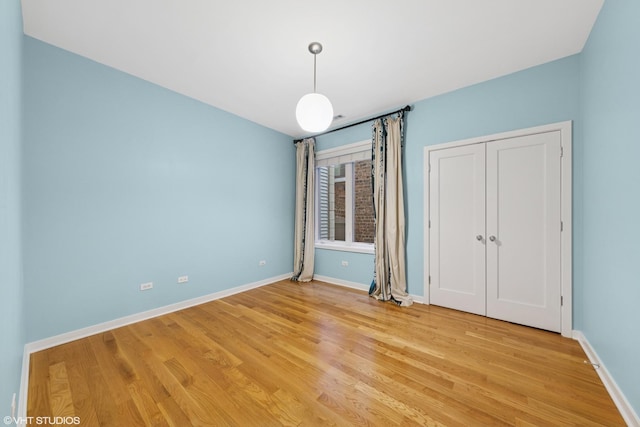 2033 N Damen Ave Unit 2N, Chicago, IL 60647 - unfurnished bedroom featuring light wood finished floors and a closet