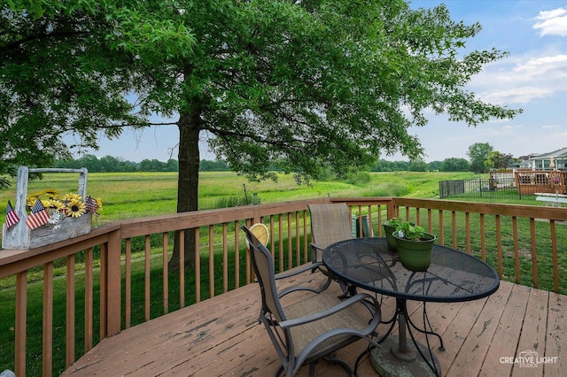 1306 Riverview Dr, Joliet, IL 60431 - deck featuring outdoor dining space, a yard, and a rural view