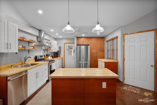 1306 Riverview Dr, Joliet, IL 60431 - kitchen featuring butcher block counters, appliances with stainless steel finishes, wall chimney range hood, a kitchen island, and dark wood-style floors