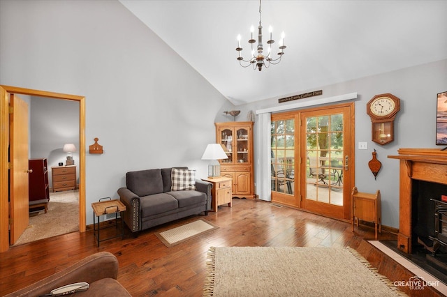 1306 Riverview Dr, Joliet, IL 60431 - living room with high vaulted ceiling, a chandelier, wood finished floors, and a fireplace with flush hearth