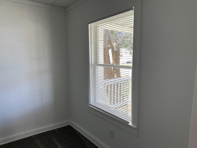 1453 S Oak Ave, Freeport, IL 61032 - empty room featuring baseboards and dark colored carpet