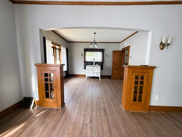 207 College Ave, Dixon, IL 61021 - unfurnished dining area with wood finished floors, ornamental molding, and arched walkways