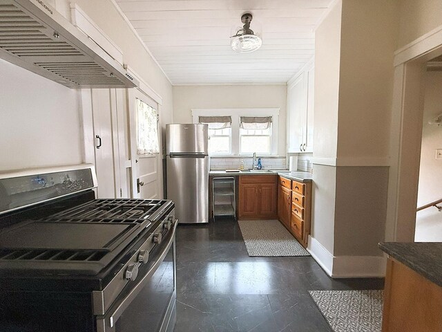 207 College Ave, Dixon, IL 61021 - kitchen with appliances with stainless steel finishes, extractor fan, brown cabinets, and beverage cooler