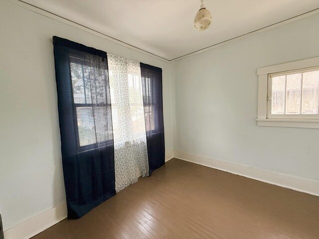 207 College Ave, Dixon, IL 61021 - unfurnished room featuring baseboards and dark wood-type flooring