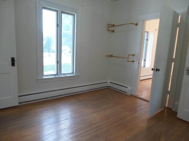 1201 Old Indian Town Rd, Henry, IL 61537 - empty room featuring a baseboard heating unit and hardwood / wood-style flooring