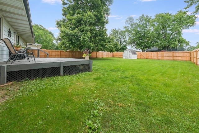 305 E Marshall St, Tolono, IL 61880 - fenced backyard featuring a wooden deck and a storage unit