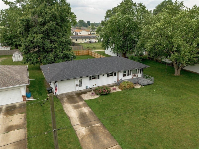 305 E Marshall St, Tolono, IL 61880 - view of front facade with concrete driveway, a front lawn, and an attached garage