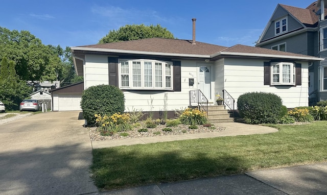 411 1st Ave, Ottawa, IL 61350 - view of front facade with entry steps, an outbuilding, a front yard, and a detached garage