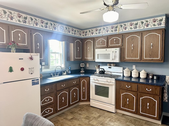 411 1st Ave, Ottawa, IL 61350 - kitchen featuring white appliances, dark countertops, and dark brown cabinetry