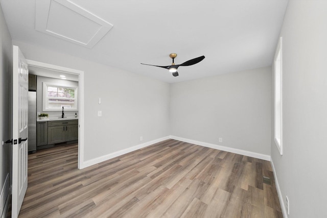 114 Maple St, Mchenry, IL 60051 - unfurnished room with attic access, light wood-type flooring, and ceiling fan