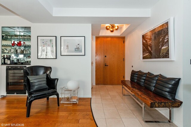 40 E Delaware Pl Unit 1502, Chicago, IL 60611 - foyer entrance with beverage cooler, a dry bar, light wood-style floors, and a raised ceiling