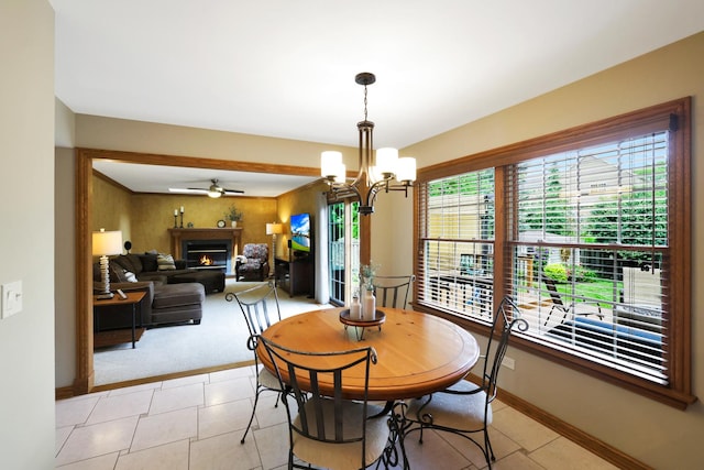 747 Warwick Ct, Carol Stream, IL 60188 - dining space featuring a chandelier, light carpet, a warm lit fireplace, light tile patterned floors, and a ceiling fan