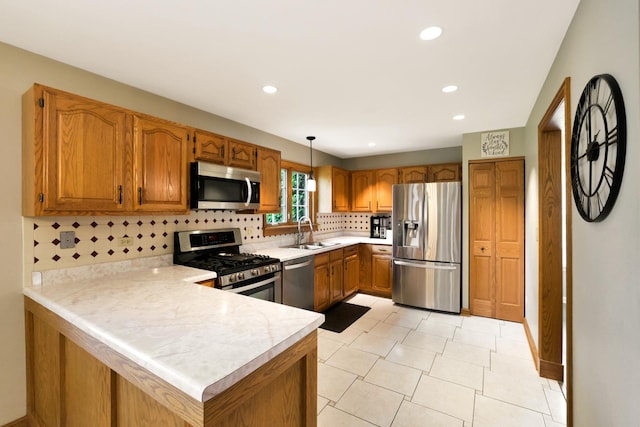 747 Warwick Ct, Carol Stream, IL 60188 - kitchen featuring appliances with stainless steel finishes, light countertops, brown cabinetry, a peninsula, and tasteful backsplash