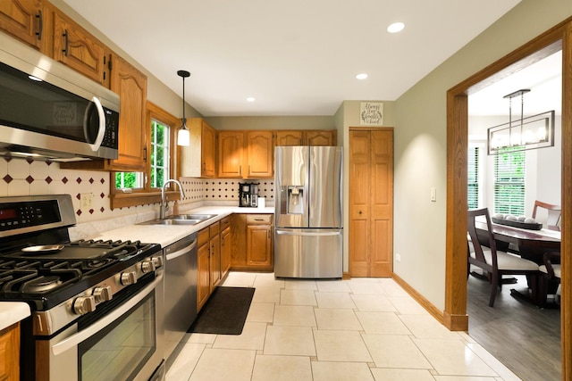747 Warwick Ct, Carol Stream, IL 60188 - kitchen featuring appliances with stainless steel finishes, light countertops, healthy amount of natural light, tasteful backsplash, and recessed lighting