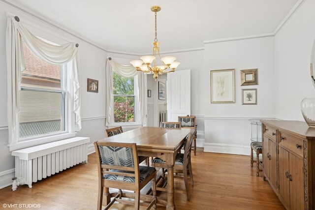 235 S Grove Ave, Oak Park, IL 60302 - dining area featuring radiator heating unit, a chandelier, light wood-type flooring, and ornamental molding