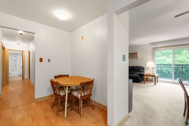 dining space featuring light wood finished floors and a ceiling fan