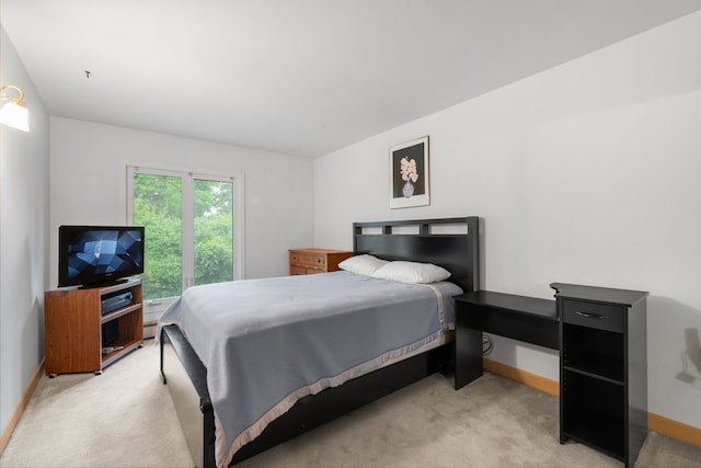 bedroom featuring light carpet and a baseboard heating unit