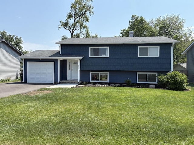 535 N Midlothian Rd, Mundelein, IL 60060 - tri-level home with an attached garage, a front lawn, driveway, and a chimney