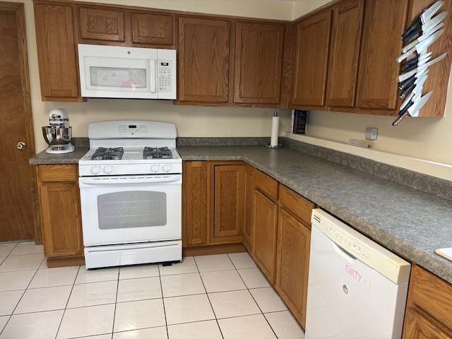 535 N Midlothian Rd, Mundelein, IL 60060 - kitchen featuring white appliances, dark countertops, brown cabinets, and light tile patterned flooring