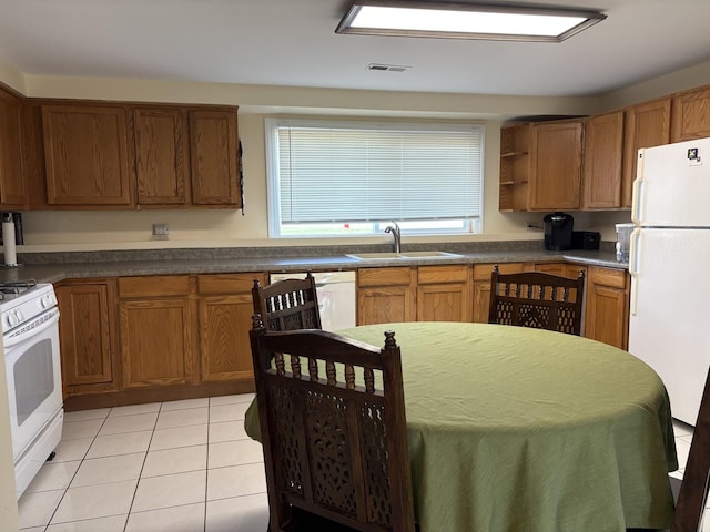 535 N Midlothian Rd, Mundelein, IL 60060 - kitchen featuring white appliances, light tile patterned floors, brown cabinets, and open shelves