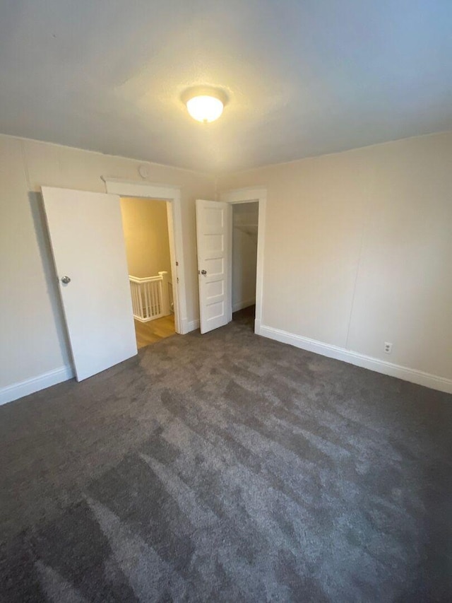 1350 E Chestnut St, Kankakee, IL 60901 - unfurnished bedroom with dark colored carpet and baseboards