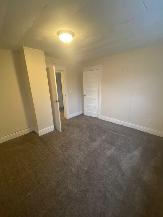 1350 E Chestnut St, Kankakee, IL 60901 - empty room with dark carpet and baseboards