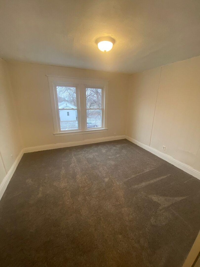 1350 E Chestnut St, Kankakee, IL 60901 - empty room with dark carpet and baseboards
