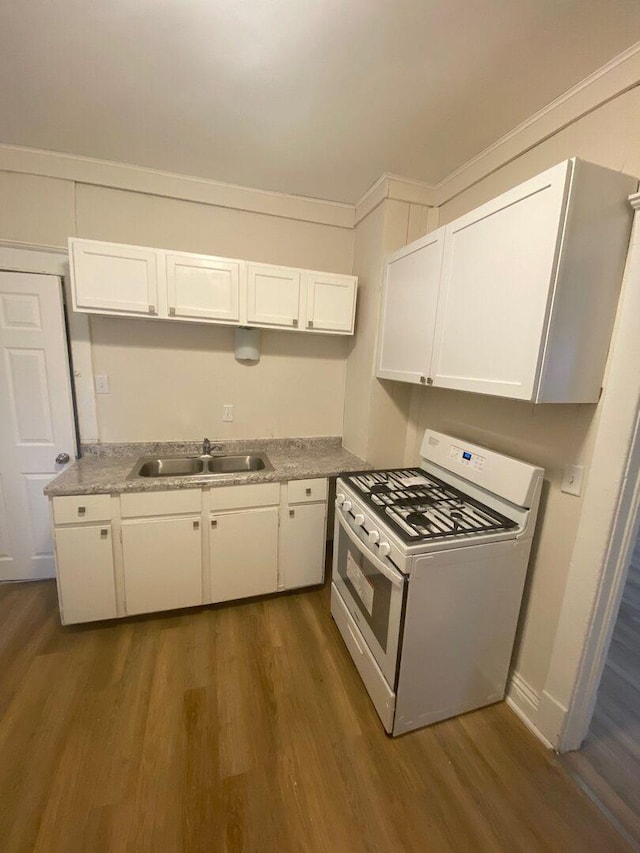 1350 E Chestnut St, Kankakee, IL 60901 - kitchen featuring white gas stove, dark wood-type flooring, white cabinets, and light countertops