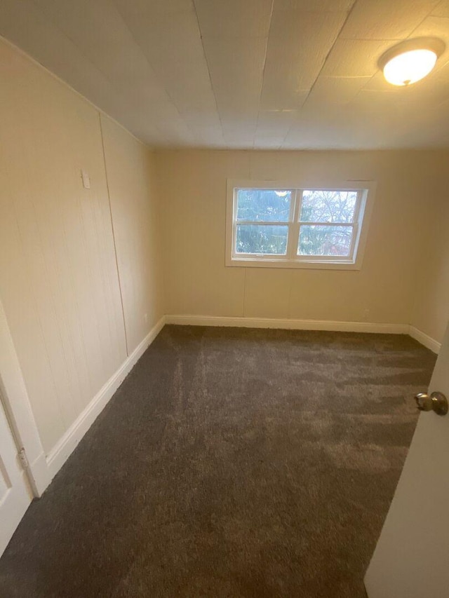 1350 E Chestnut St, Kankakee, IL 60901 - spare room with dark colored carpet and baseboards