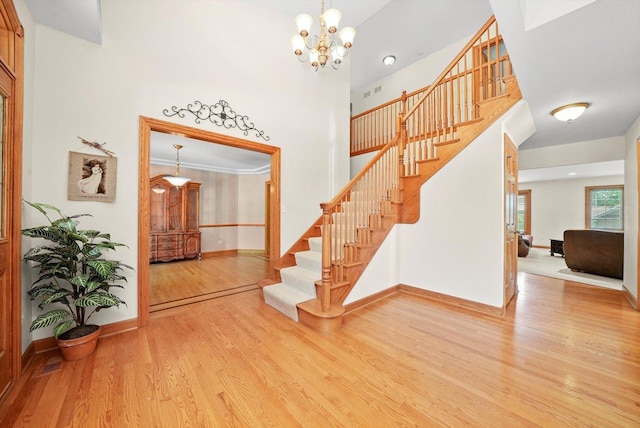 15501 116th Ct, Orland Park, IL 60467 - staircase featuring wood finished floors, a chandelier, and a towering ceiling