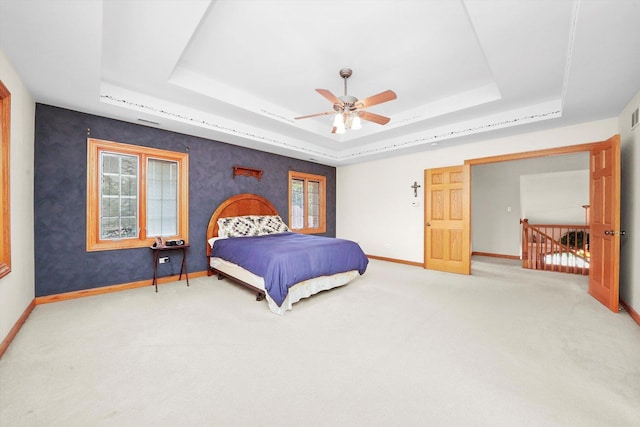 15501 116th Ct, Orland Park, IL 60467 - carpeted bedroom with a tray ceiling and a ceiling fan
