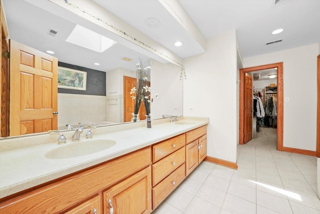15501 116th Ct, Orland Park, IL 60467 - bathroom with a skylight, double vanity, recessed lighting, tile patterned floors, and a spacious closet