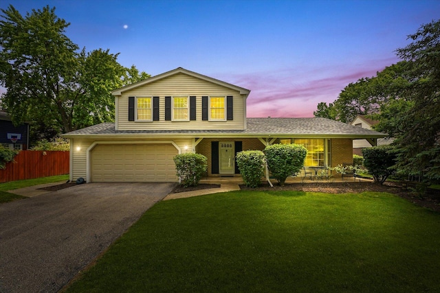 1554 Chickasaw Dr, Naperville, IL 60563 - traditional home featuring asphalt driveway, an attached garage, a shingled roof, covered porch, and brick siding