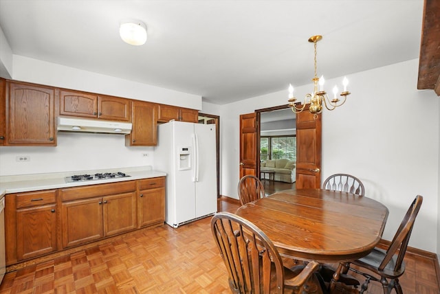 1554 Chickasaw Dr, Naperville, IL 60563 - kitchen featuring white appliances, under cabinet range hood, a chandelier, light countertops, and pendant lighting