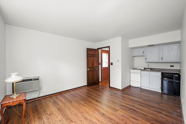1554 Chickasaw Dr, Naperville, IL 60563 - kitchen with dark wood finished floors, electric stove, dark countertops, a wall unit AC, and gray cabinetry