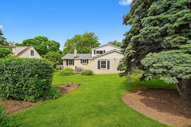 1554 Chickasaw Dr, Naperville, IL 60563 - rear view of property with a chimney, a yard, brick siding, and a patio area