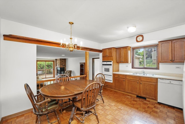 1554 Chickasaw Dr, Naperville, IL 60563 - kitchen with white appliances, light countertops, brown cabinetry, and pendant lighting