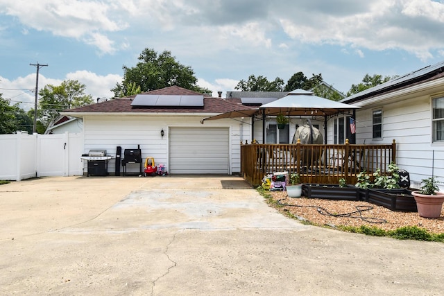 109 E Seminole St, Dwight, IL 60420 - ranch-style home featuring solar panels, concrete driveway, an attached garage, a gazebo, and a shingled roof