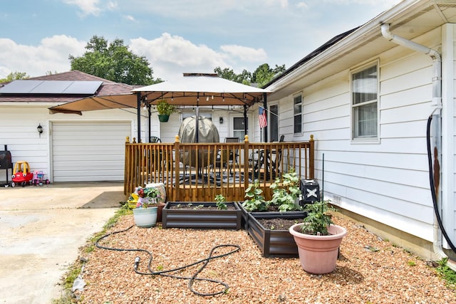 109 E Seminole St, Dwight, IL 60420 - wooden deck with a garage, a gazebo, and concrete driveway